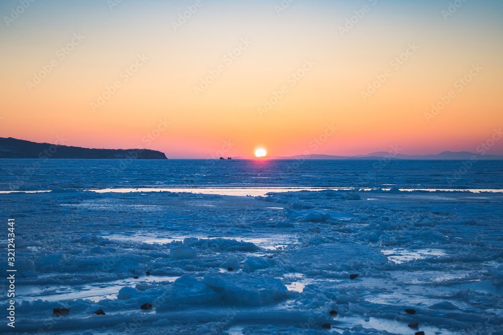 Seascape with sunset view over the icy surface. Seascape with sunset view over the icy surface.