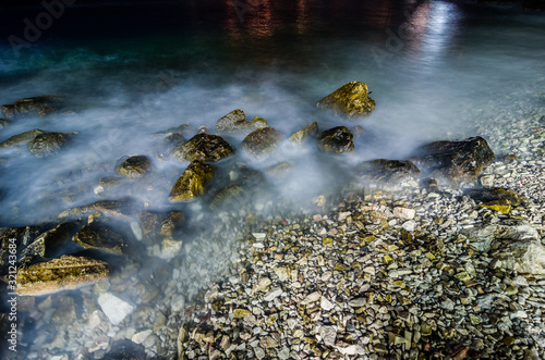 Coast of the sea in Sarande with stones at night on long exposure