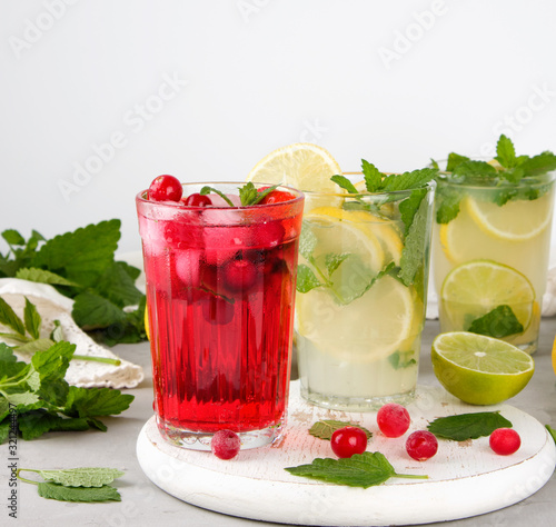 refreshing summer drink of strawberries and cranberries on a white wooden board