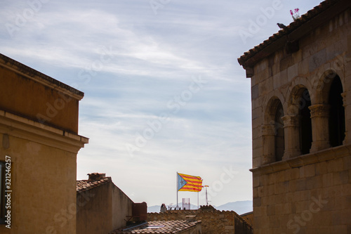 The Estelada (starred flag) symbolizing Catalan independence hanging out of a building in Catalonia photo