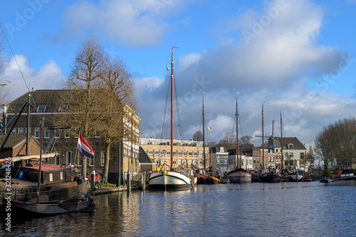 Traditional Dutch cityscape of a harbor with historic inland vessels.