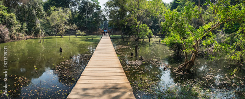 Photos Mysterious wooden path to Neak Pean Temple through beautiful lake in Angkor Complex, Siem Reap, Cambodia