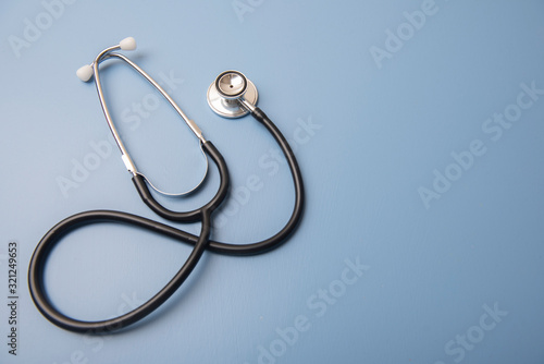Stethoscope on blue background with copy space 