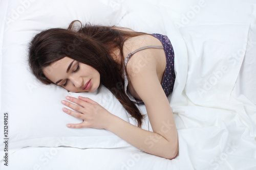 Rest relax recovery sleep dream concept. Young exhausted lady relaxing sleeping dreaming in bed.