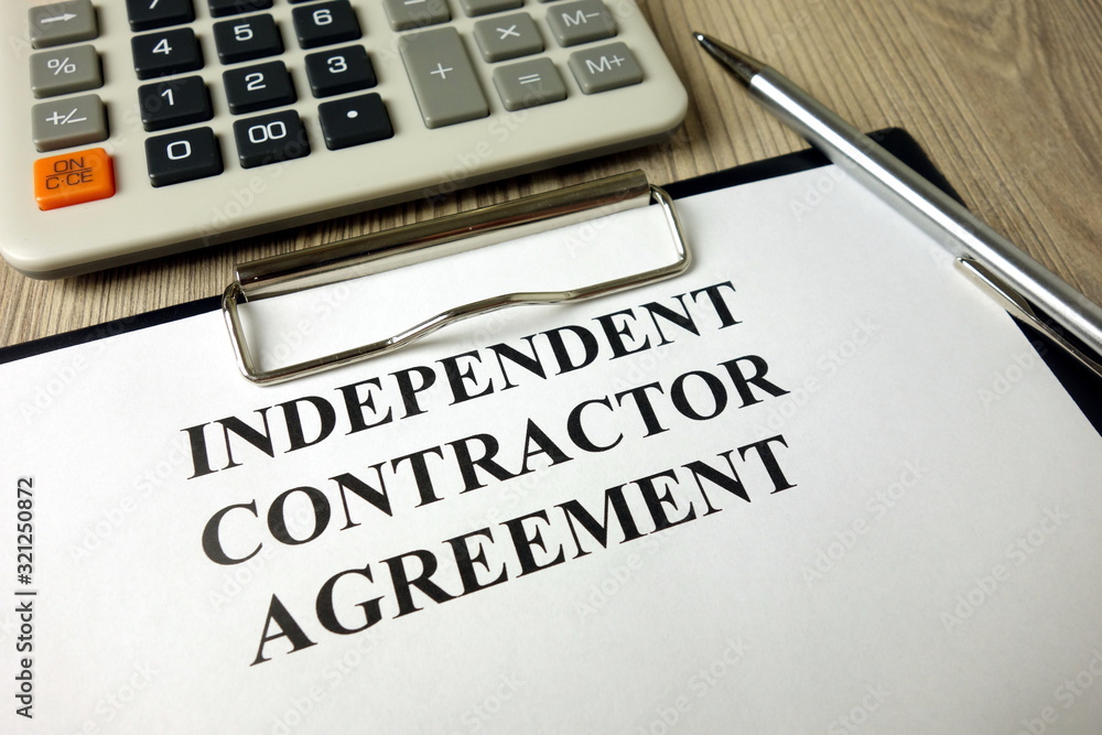 Independent Contractor Agreement with calculator and pen Independent Contractor Agreement with calculator and pen
