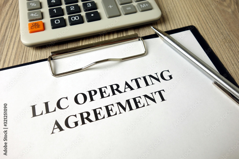 LLC operating agreement, pen and calculator on desk