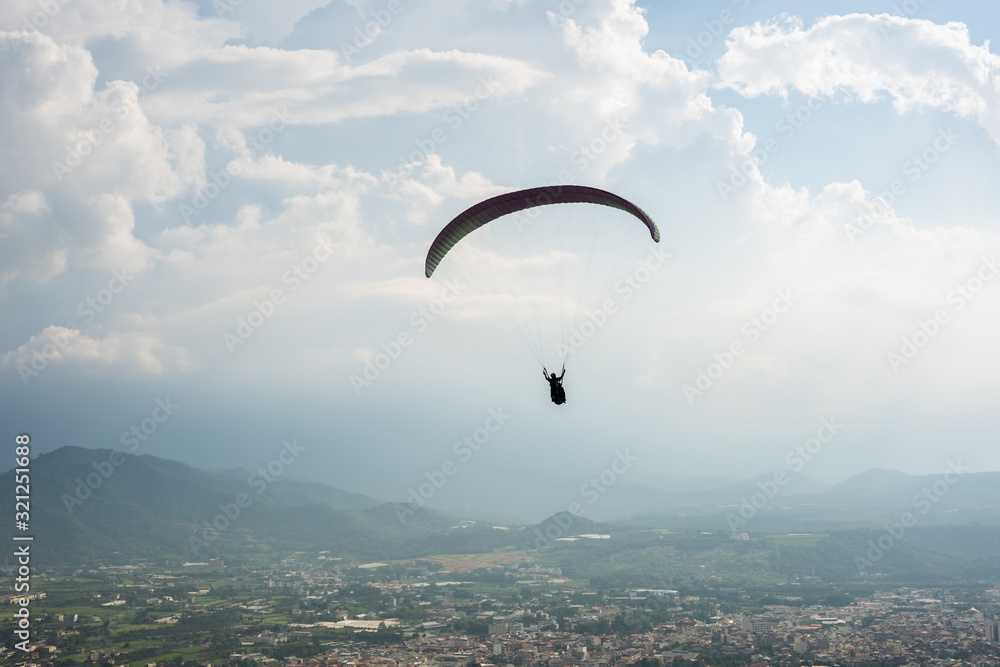 colorful paragliding over blue sky at town colorful paragliding over blue sky at town