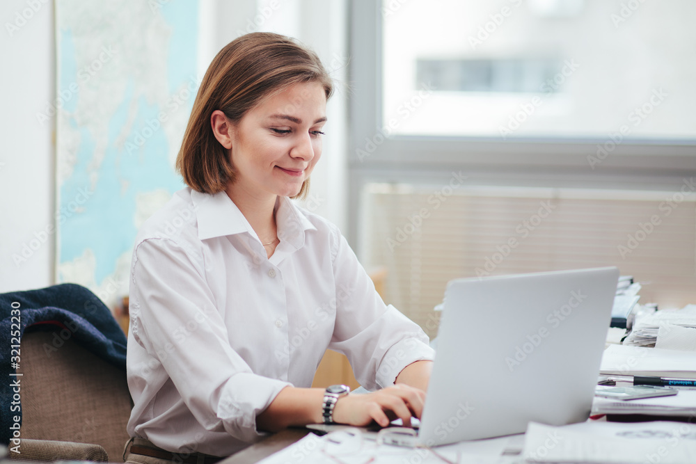 Woman in office working, reading a document Woman in office working, reading a document