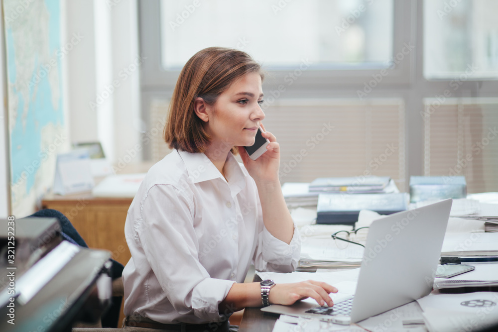 Woman in office working, reading a document Woman in office working, reading a document