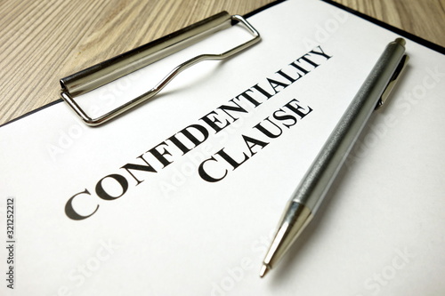 Confidentiality clause with pen on desk