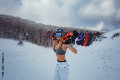 Female snowboarder hold snowboard and going to snowboarding