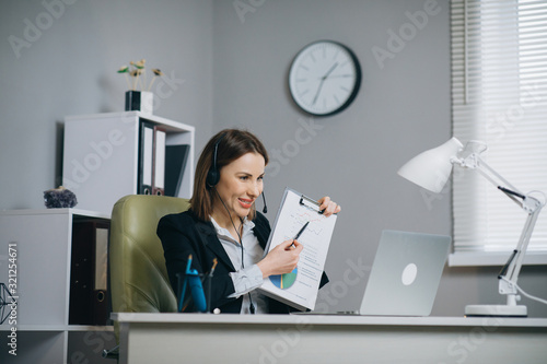 Tableau sur toile Woman Holding Paper Financial Report Talk at Webcam make Video Call in Office, B