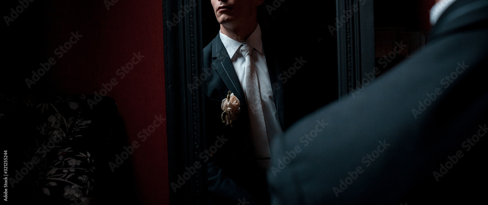 Elegant man clothing of a groom in a mirror reflection in dark - obrazy, fototapety, plakaty 