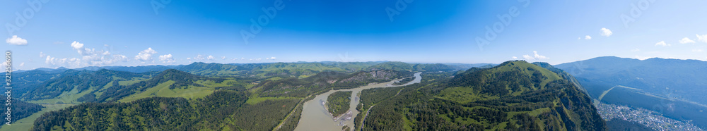 Aerial banner panoramic wide view of planet earth with nature and picturesque landscape in Altai mountain with green trees on a summer day and blue sky. Travel and recreation.