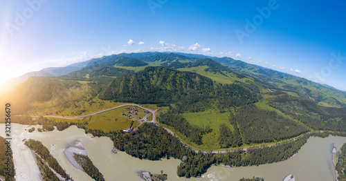 Foto Aerial view of planet earth with nature and picturesque landscape near a mountain along river and green trees on a summer day and blue sky
