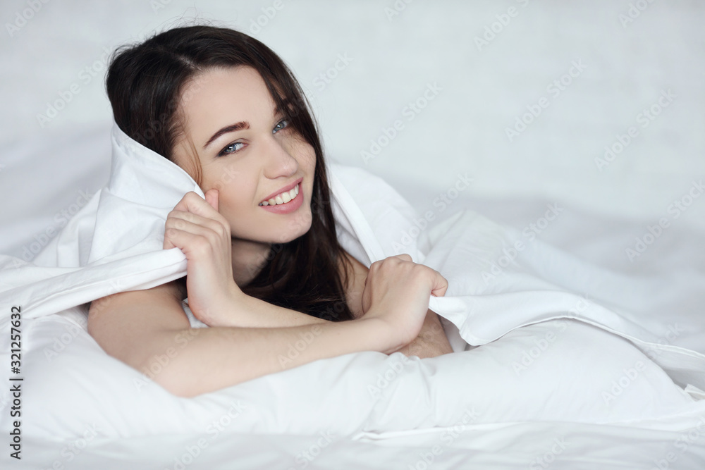 Young beautiful woman sleeping in her bed and relaxing in the morning. Young beautiful woman sleeping in her bed and relaxing in the morning.