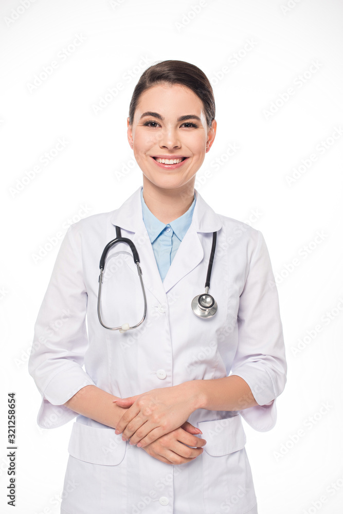 Attractive doctor in white coat and stethoscope smiling at camera isolated on white Attractive doctor in white coat and stethoscope smiling at camera isolated on white