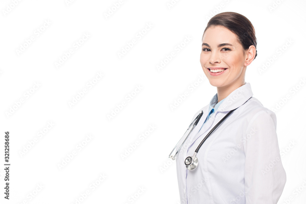 Attractive doctor in white coat and stethoscope smiling at camera isolated on white Attractive doctor in white coat and stethoscope smiling at camera isolated on white