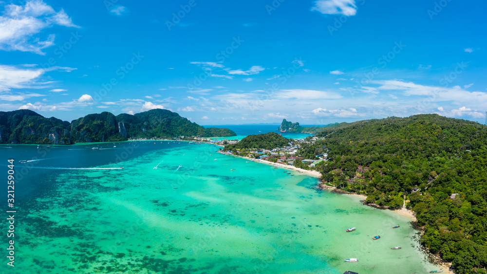Panorama of tropical islands Phi Phi Don and Phi Phi Leh in sea. Vacation holidays concept background. Aerial view of Tonsai bay with many boats and speedboats above coral reef.  Krabi, Thailand