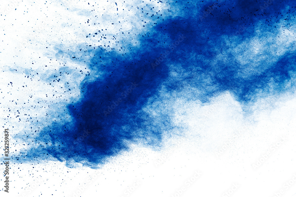 Abstract blue dust explosion on white background. Freeze motion of blue holi powder splash.