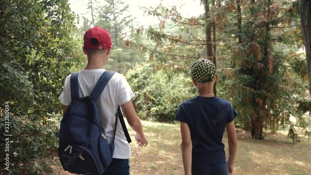 Two boys are hiking. Teamwork in recreation and tourism. Happy family. Two boys are hiking. Teamwork in recreation and tourism. Happy family.