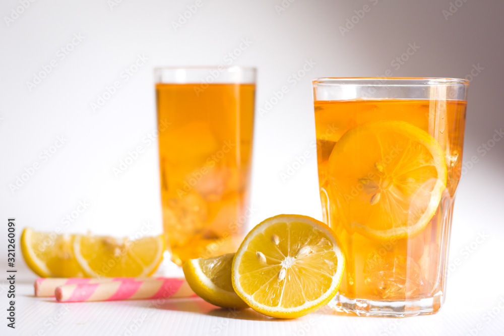Glasses of ice tea with lemon slices and mint on white background Glasses of ice tea with lemon slices and mint on white background