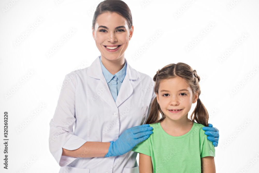 Pediatrician hugging kid and smiling at camera isolated on white Pediatrician hugging kid and smiling at camera isolated on white