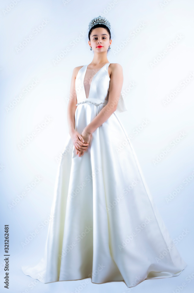 Fototapeta premium beautiful bride posing in white dress with wedding, isolated on a light background