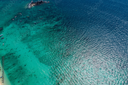 Aerial drone photo of iconic tropical turquoise water Pileh Lagoon surrounded by limestone cliffs, Phi phi islands, Thailand. Ao Pi Leh Lagoon at Beautiful sea and blue sky at Similan island,Thailand © netsay