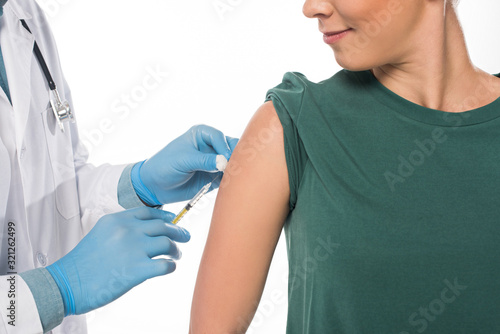 Cropped view of doctor doing vaccine injection to patient isolated on white