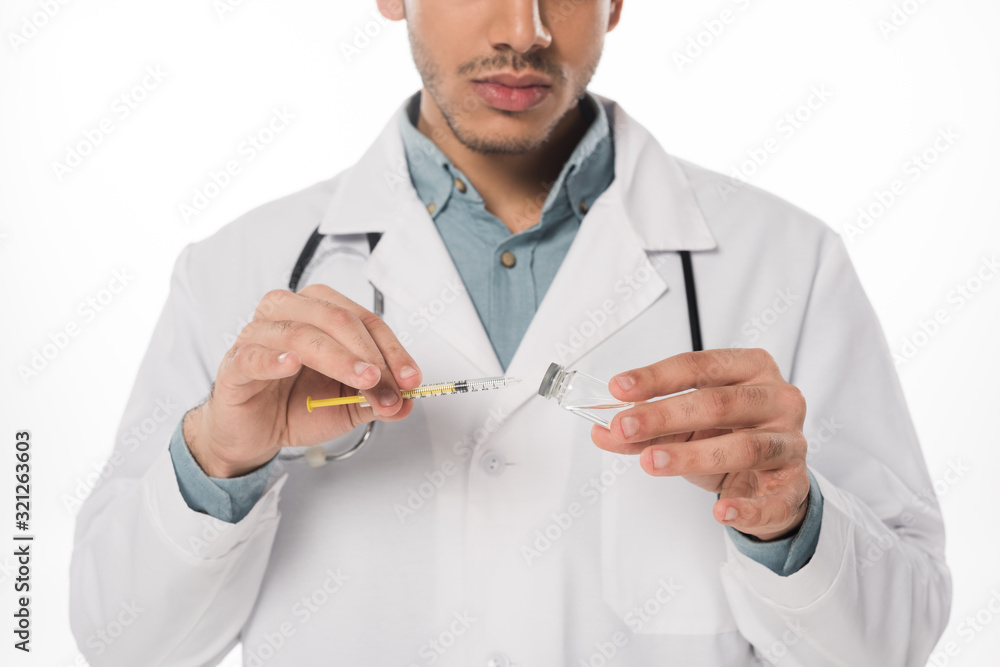 Cropped view of doctor picking up vaccine in syringe isolated on white Cropped view of doctor picking up vaccine in syringe isolated on white