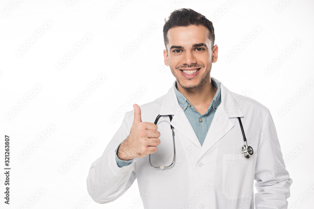 Handsome doctor showing thumb up and smiling at camera isolated on white Handsome doctor showing thumb up and smiling at camera isolated on white