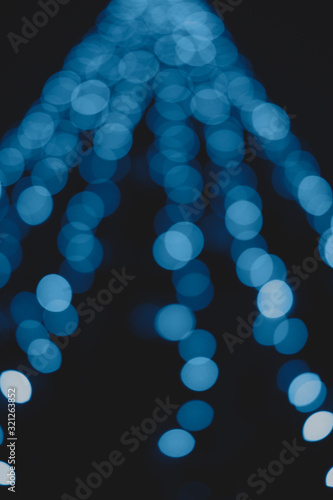 Beautiful and different bokeh lights of the night city in classic blue color.