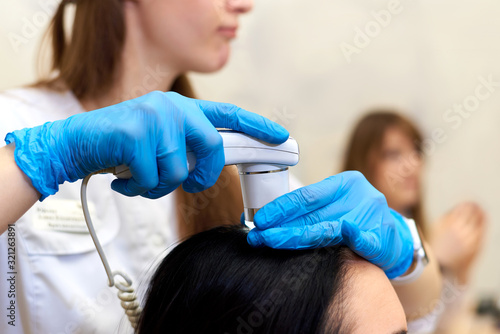 Microscopic examination of the hair and skin of the scalp.