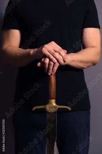 Young Athletic Man Holding His Sword