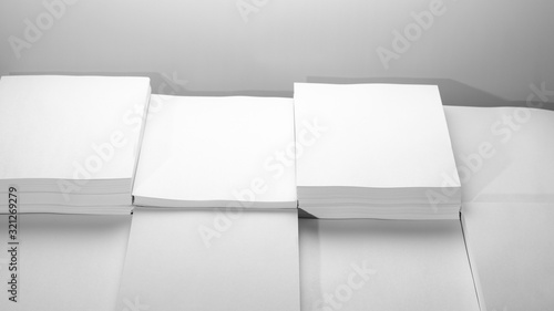 Several stacks of white paper on a white background