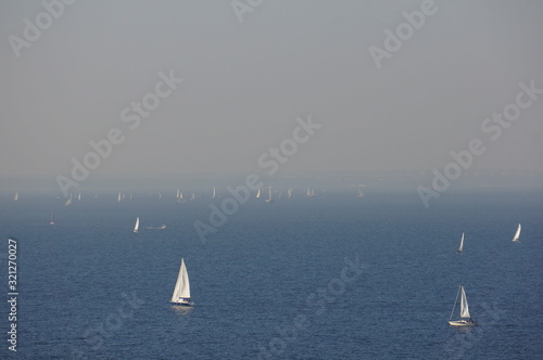 Fog over the bay and many small yachts.