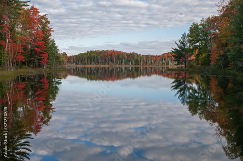 Autumn, Council Lake with mirrored reflections of trees and clouds, Hiawatha National Forest, Michigan's Upper Peninsula, USA photo