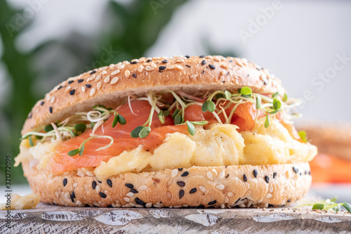 Breakfast sandwich on bagel with salmon and scrumbled egg photo