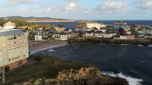 San Ciprian or San Cibrao das Vinas, coastal village of Galicia, Spain. Close view the beach and colorful houses. Drone footage rotating from right to left photo