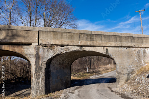 фотографія Old rural railroad bridge with crumbling, cracking concrete