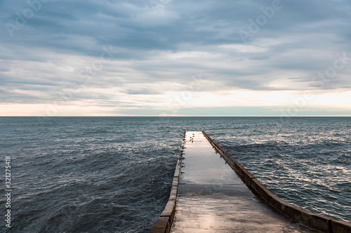 Stone pier. Concrete pier. Sea in winter. Black Sea.