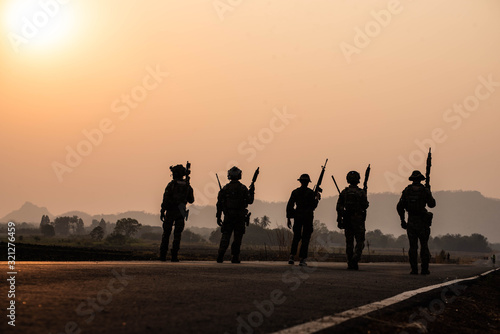 Soldier with a gun in Silouette. Silouette in solder of sunset