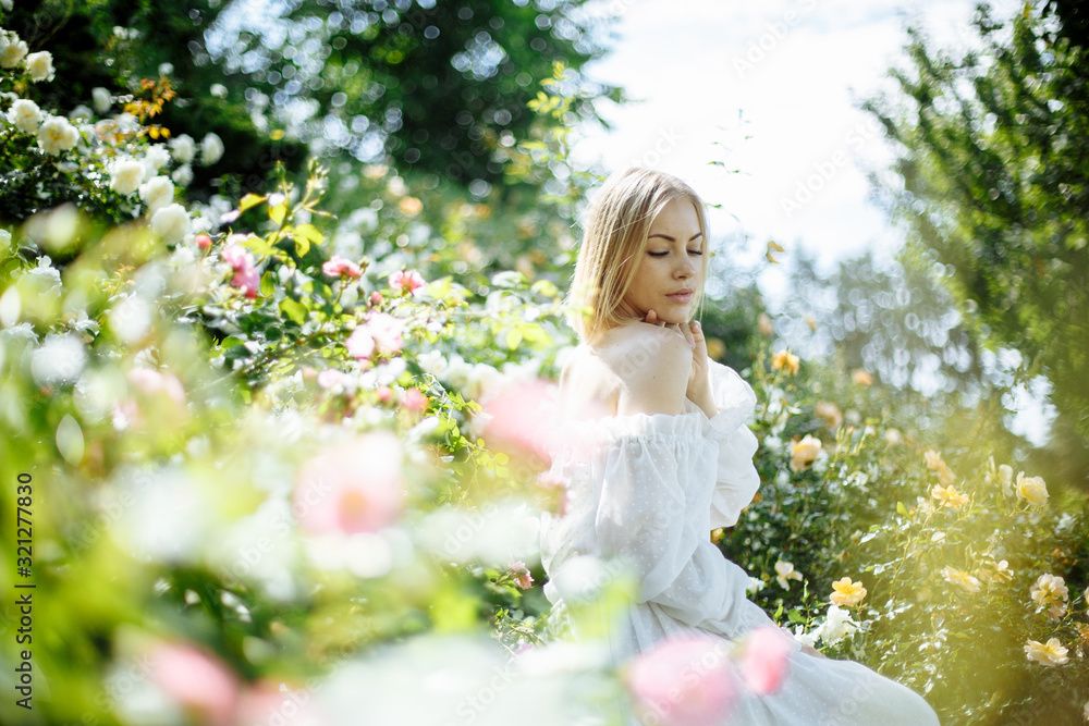 girl in a white dress among flowers girl in a white dress among flowers