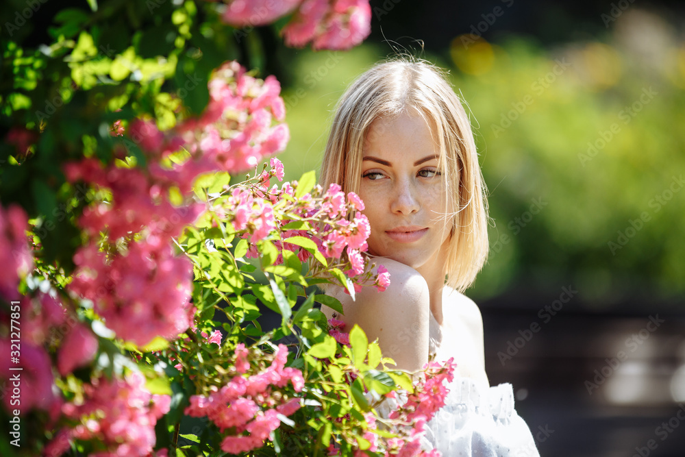Fototapeta premium girl in a white dress among flowers