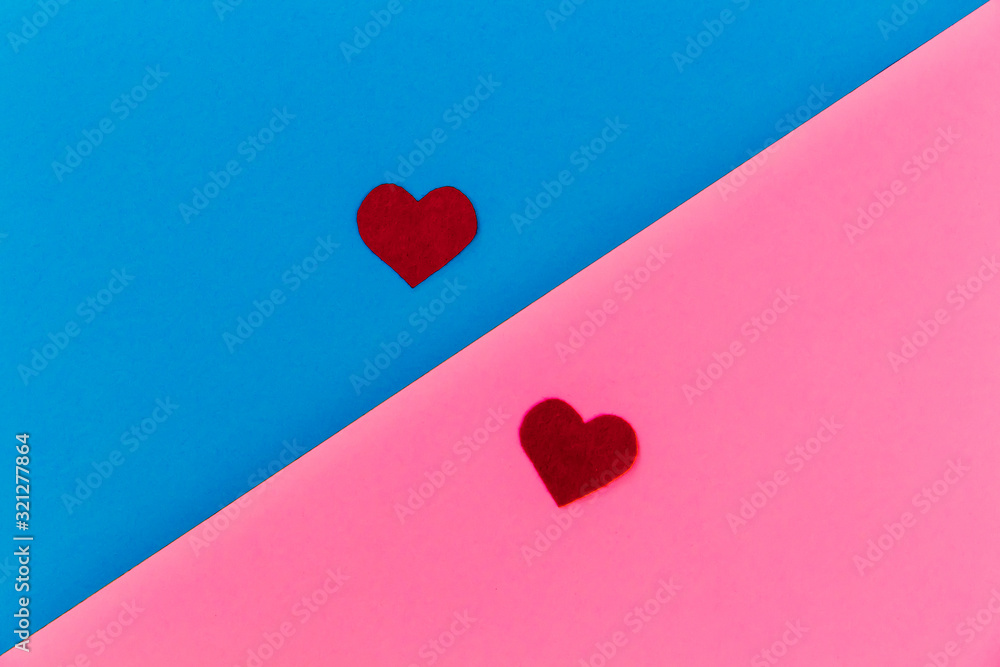 Two red felt hearts lie on a two-tone pink-blue background. Minimalism. Breakfast - Tea for Valentine's Day, Mother's Day. Holiday concept. Place for text. Two red felt hearts lie on a two-tone pink-blue background. Minimalism. Breakfast - Tea for Valentine's Day, Mother's Day. Holiday concept. Place for text.