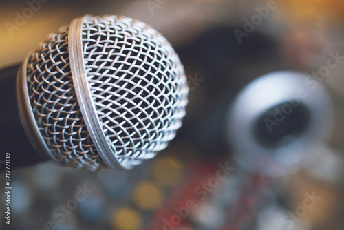 Music instruments or dj concept.the microphone and headphones on sound mixer background.