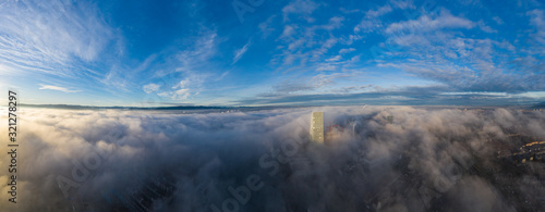 Sea of fog over the Basel city, Switzerland at sunrise shot from a drone