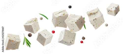 Falling feta cubes with herbs isolated on white background photo