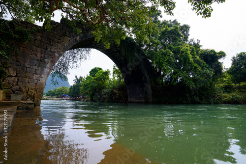 Ancient Fuli bridge by the Yulong river in Yangshuo County, Guilin, China © munettt